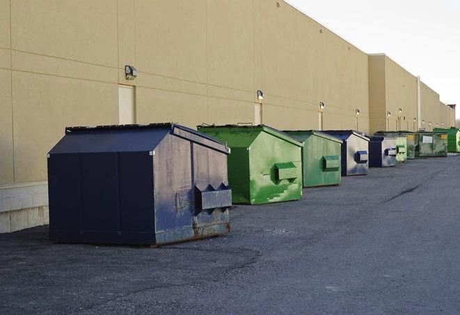 a crowd of dumpsters of all colors and sizes at a construction site in Peabody MA